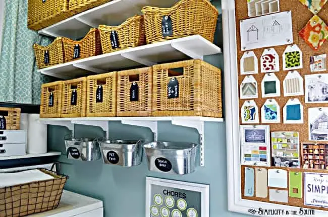 This small laundry room is big on organization ideas! Using baskets, bins, shelves along with hidden storage makes this 28 sq ft laundry room super organized and stylish.