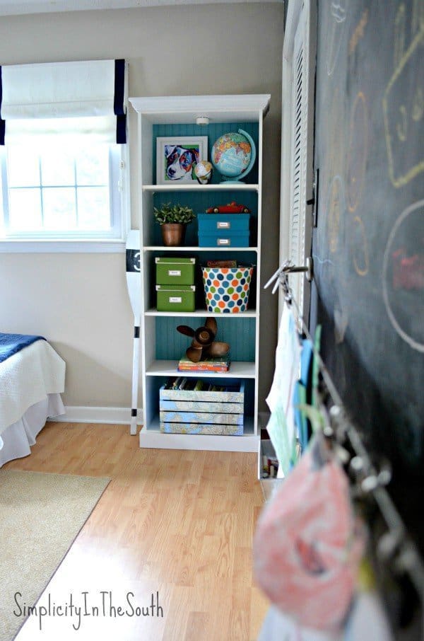 Boy's shared bedroom by Simplicity In The South. Bookcase and art wall.