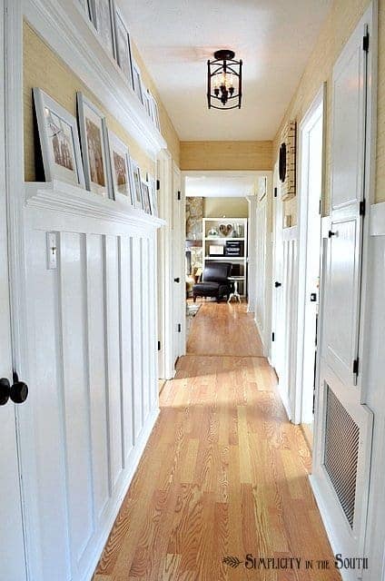 Board and batten hallway with gallery shelves