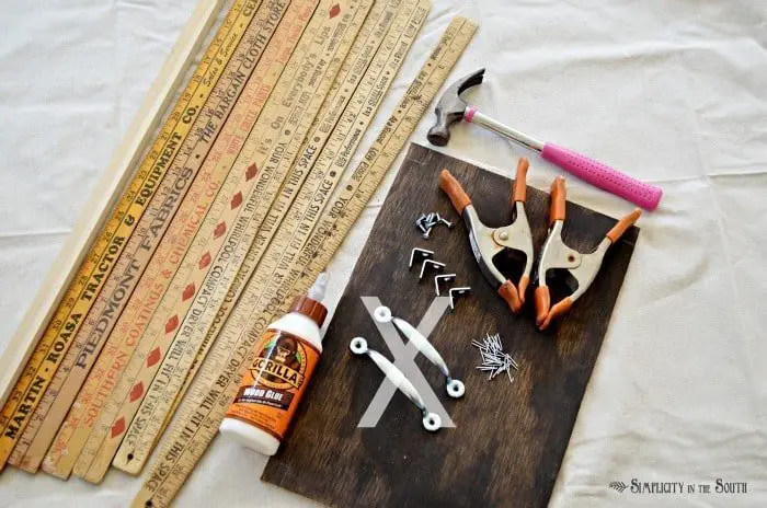 Supplies for making a yardstick tray: Add this to your list of repurposed yard stick ideas! Learn how to make a simple tray out of vintage yardsticks, plywood, L-brackets and wood glue.