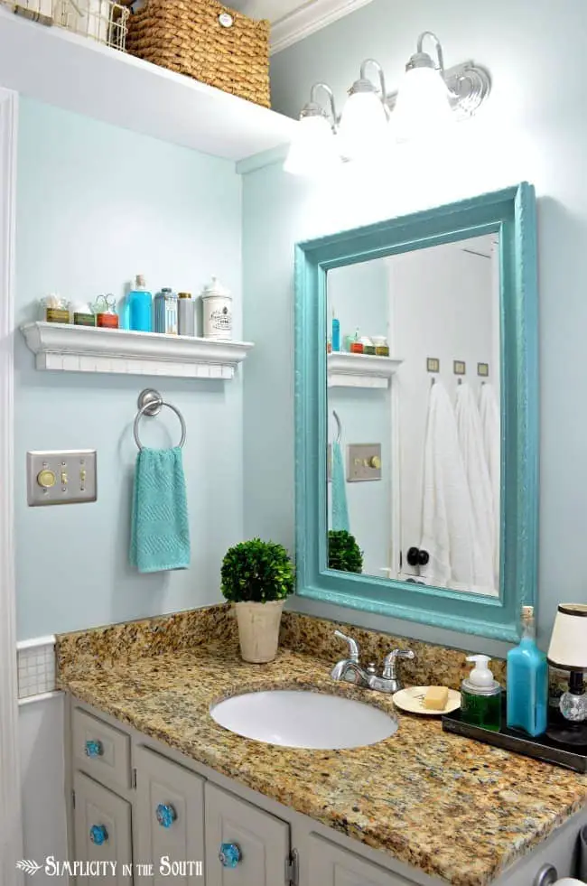 guest bathroom with turquoise mirror