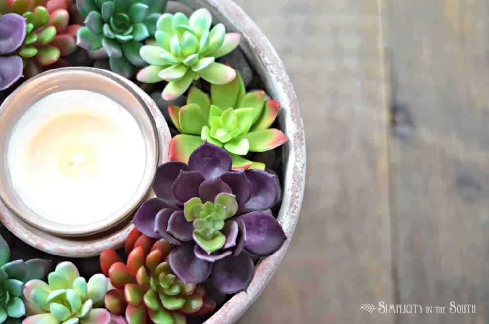 A simple and affordable faux succulent candle centerpiece that takes less than 10 minutes to make. Most supplies can be purchased at The Dollar Tree.