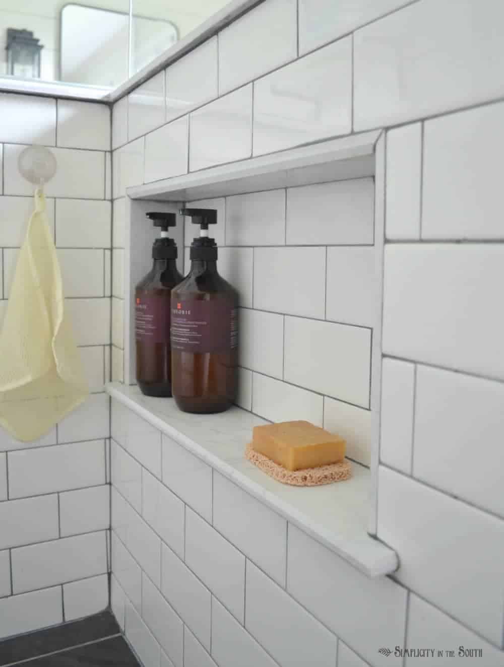 Add a hidden cubby in the shower for soap and shampoo. This is a good way to add storage in a bathroom and make it look neat and organized. 