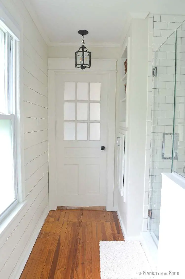A french door from a church was repurposed for the bathroom entry