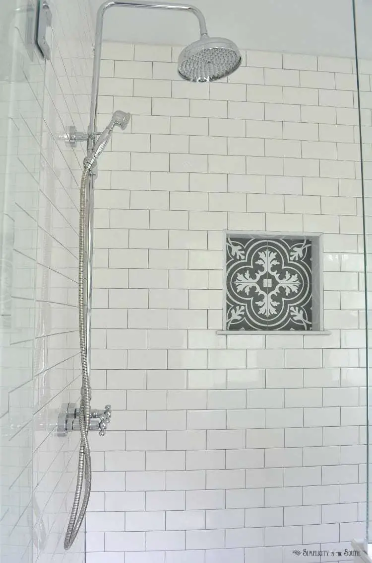 White subway tile is a classic. I love the charcoal gray grout and the patterned tile that looks like cement tile in the shower cubby