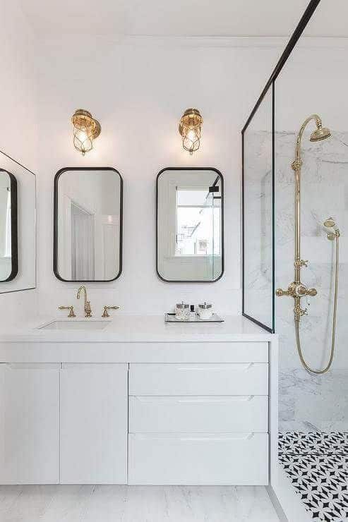 black and white bathroom with rounded rectangle mirrors via Geddes Ulinskas Architects