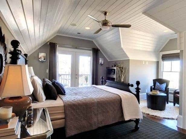 Attic bedroom with planked ceilings and medium gray paint