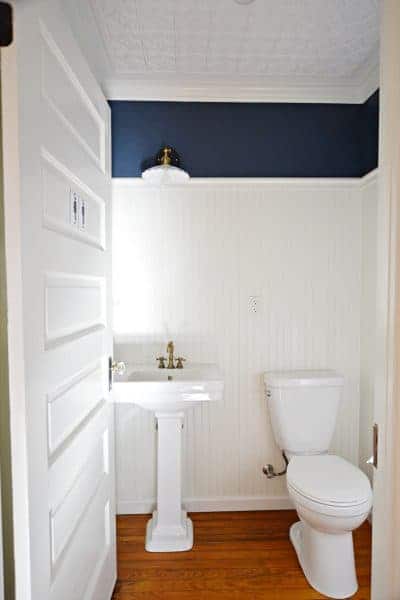 half bathroom with beadboard and faux tin ceiling