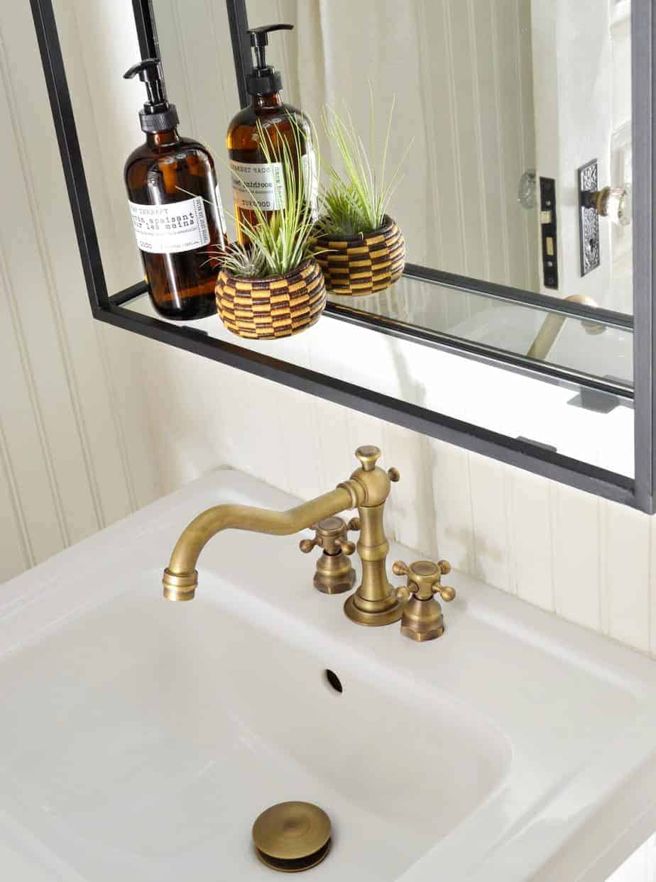 pedestal sink with widespread antique brass faucet
