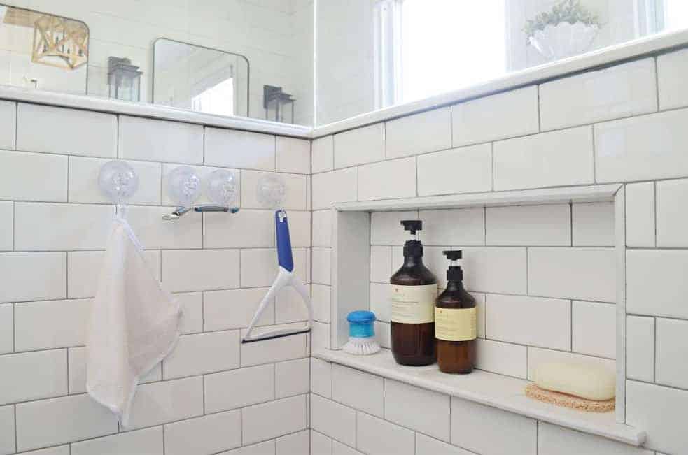 shower cubby in pony wall to organize shampoo and soap in the bathroom