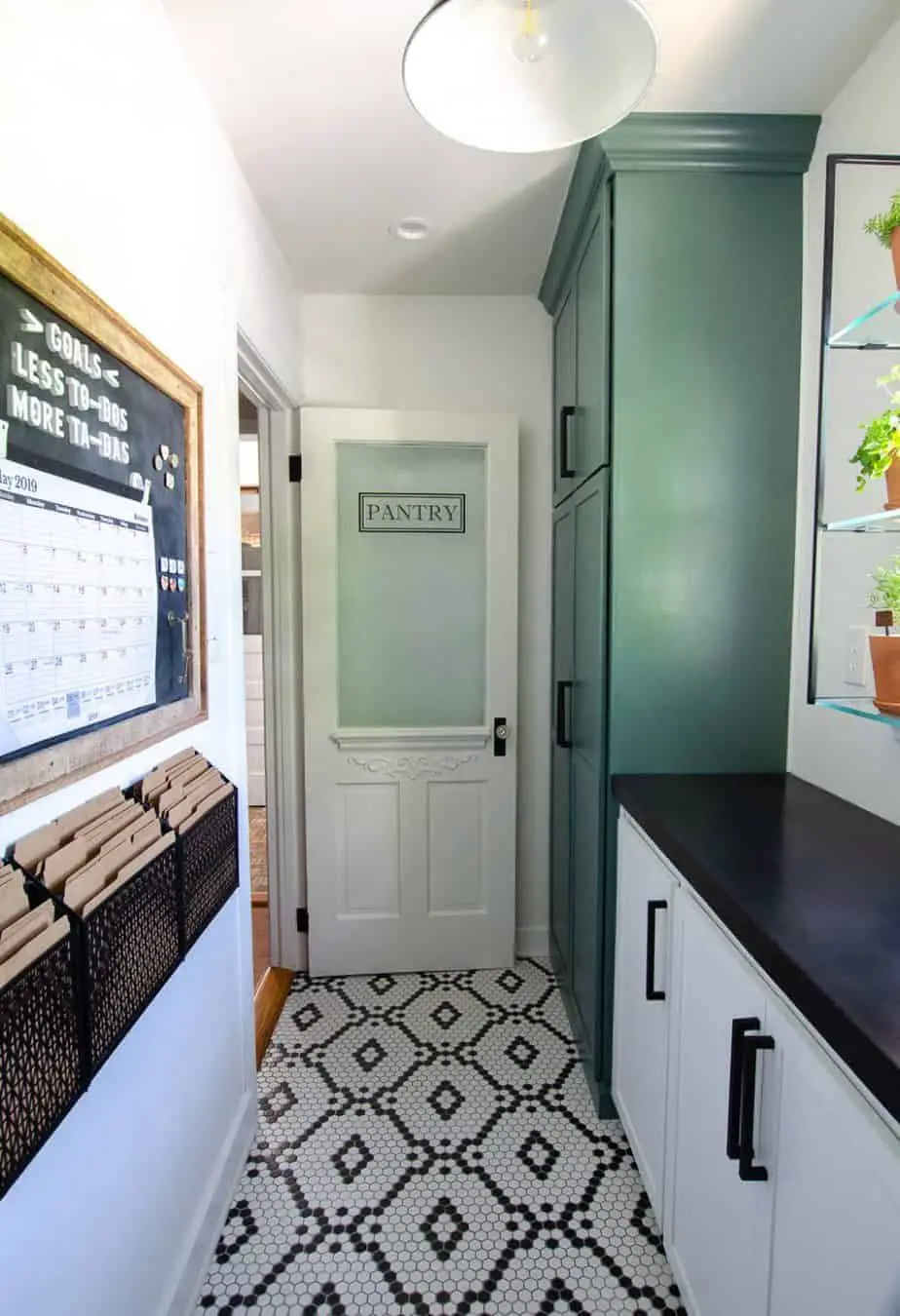narrow walk in kitchen pantry remodel with hexagon tiled floors cabinets and glass door (1)