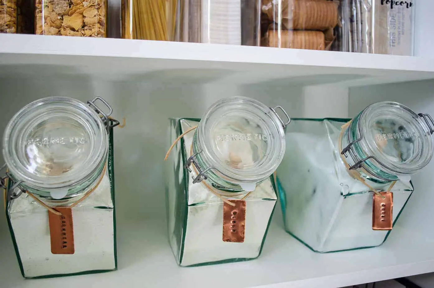 vintage glass Hermetic pantry canisters with DIY stamped copper pantry labels